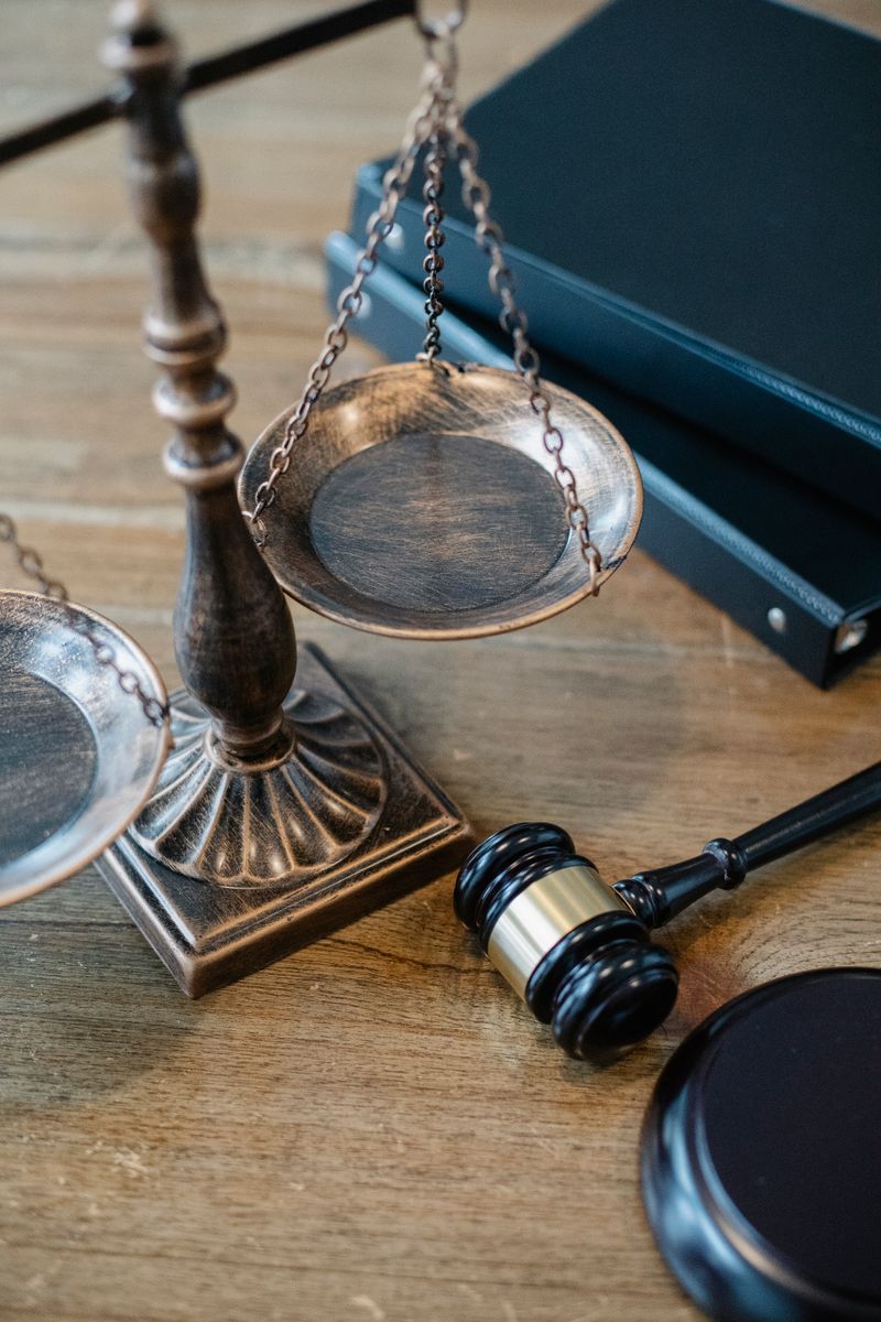 Brass scales of justice and a gavel on a desk